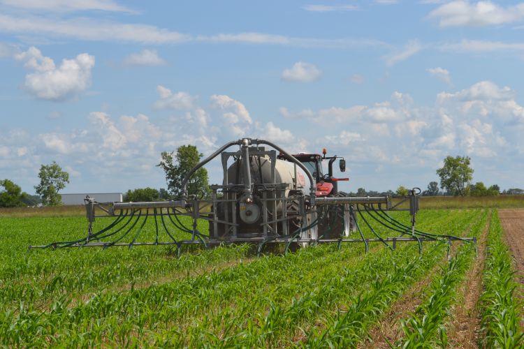 manure spreading tank in a green field