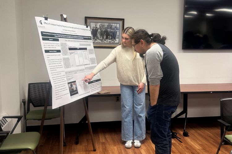 Image of students presenting their work at the Animal Science Undergraduate Research Forum.