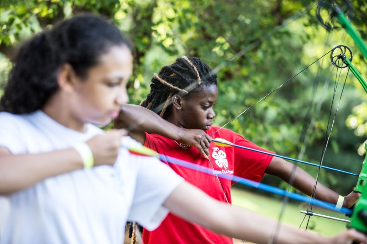 Two young ladies with bow and arrows.