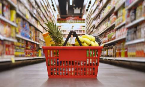 Shopping basket filled with food in a grocery store.