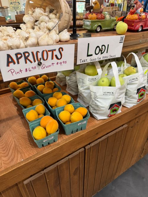 Apricots and apples for sale at a farm market.