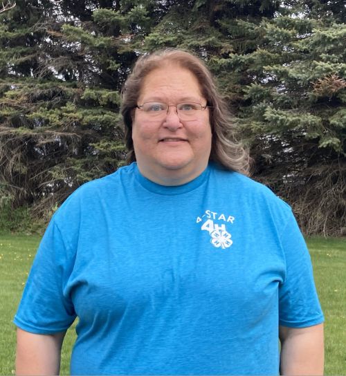 Dark haired Caucasian woman with a blue shirt.