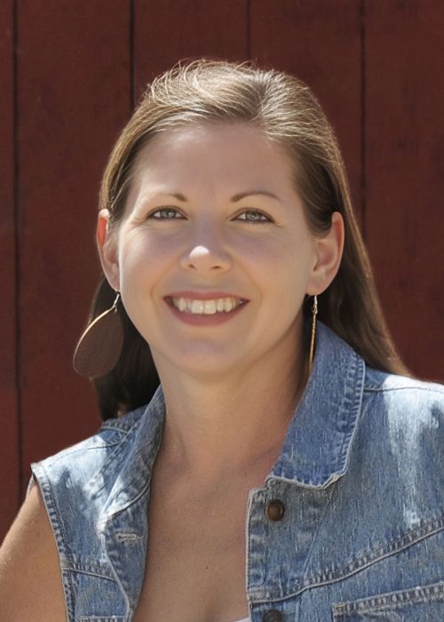 Dark haired Caucasian female in a blue jean jacket.