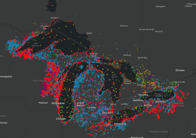 A screenshot of an interactive map in the StoryMap, showing the current distribution of the top 10 Great Lakes invaders. An aerial view of the Great Lakes watershed shows reds and blues dotting the states with some areas more concentrated in color than others.