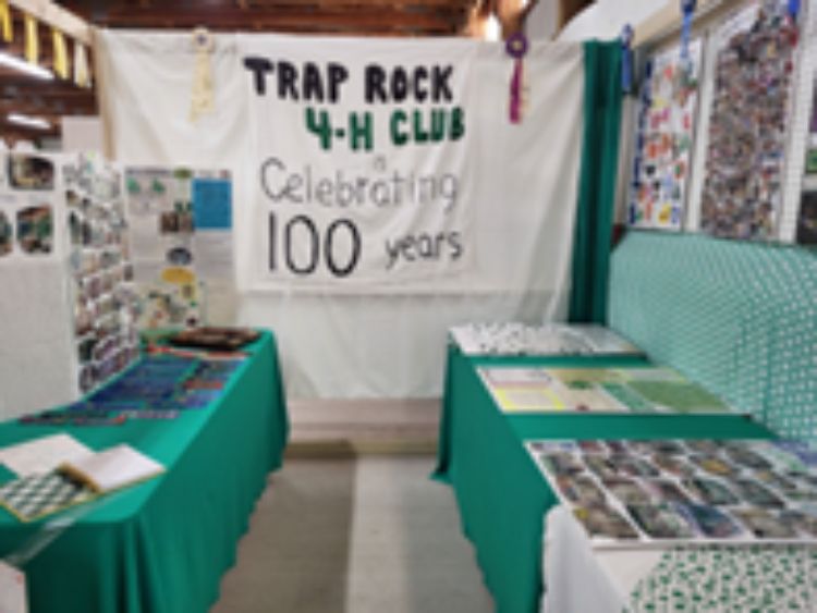 A banner on a wall that says Trap Rock 4-H Club Celebrating 100 years.
