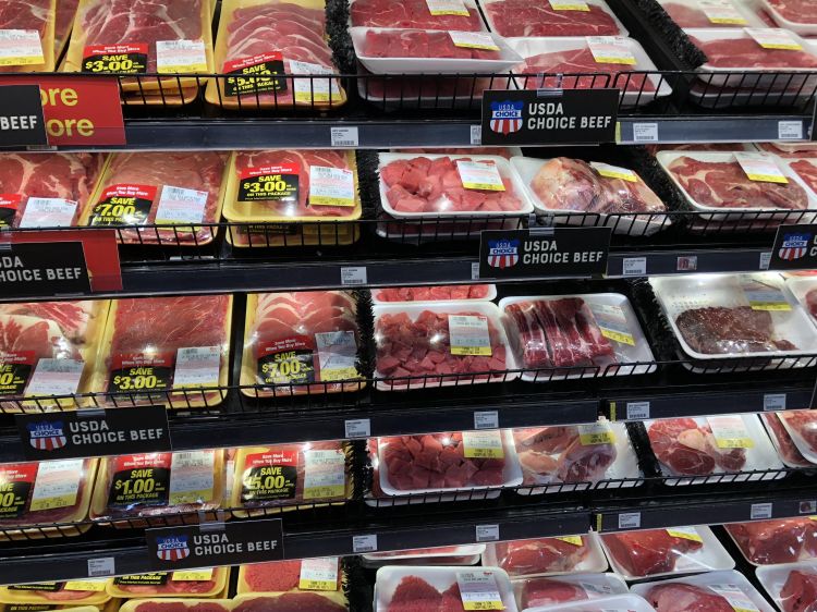 racks of packaged beef in a grocer