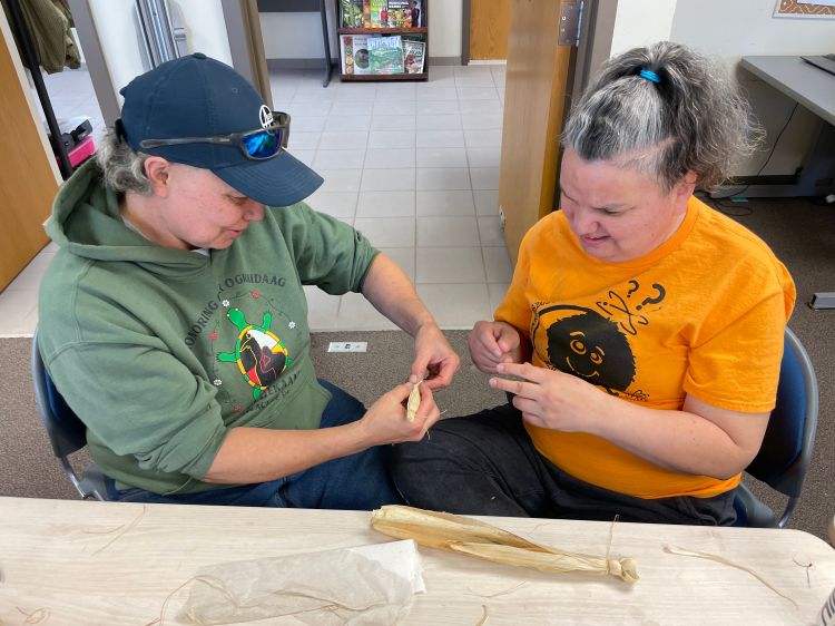 Two participants at the event work on the corn demonstration.