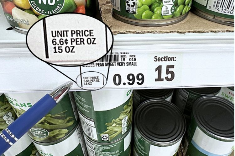 Close-up of canned peas on a shelf with a price tag reading 