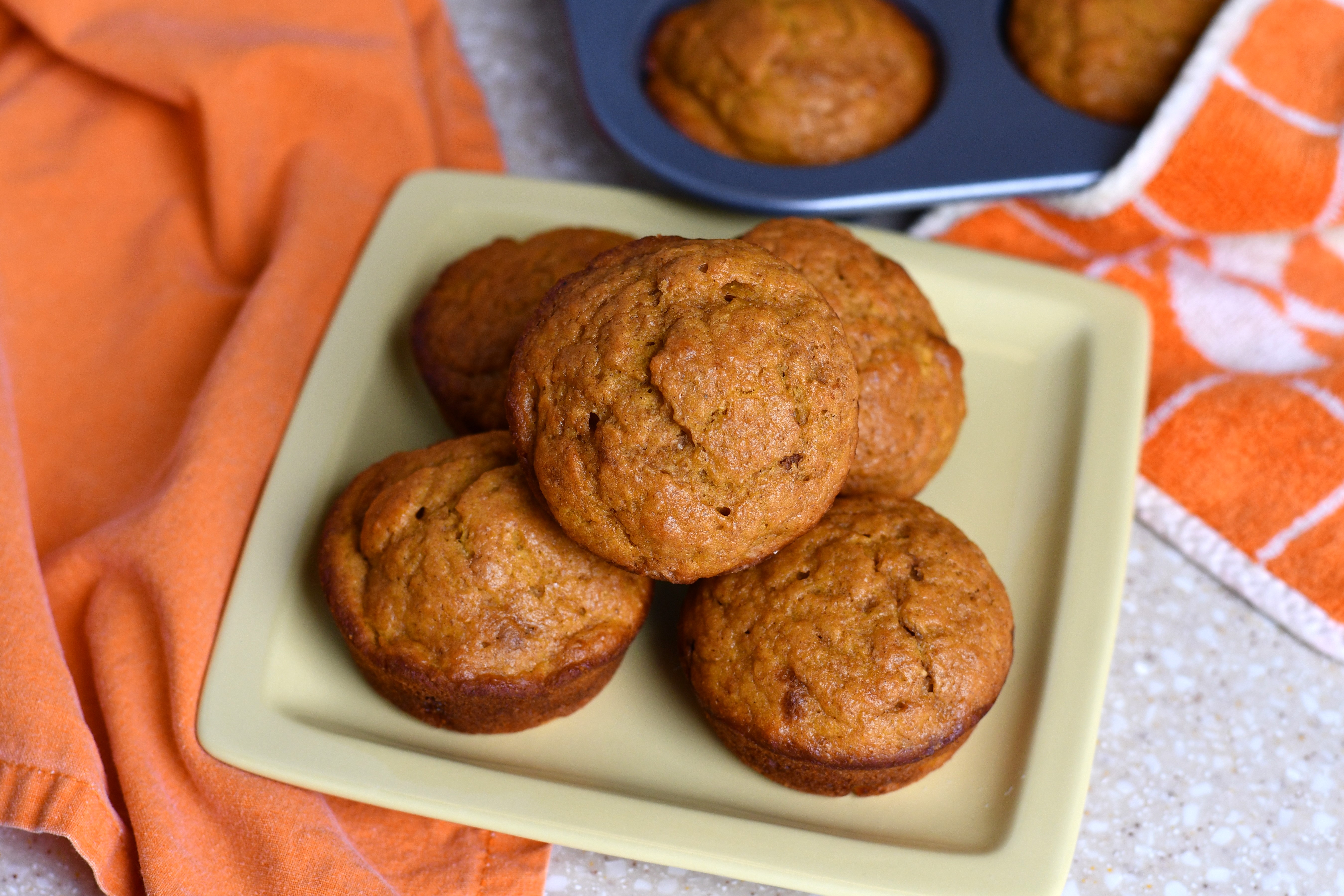 A photo of a plate of muffins on a table