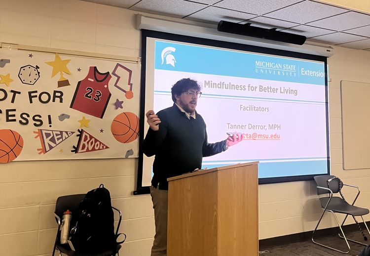 An MSU Extension Health Educator, Tanner Derror presents on mindfulness at a local library.