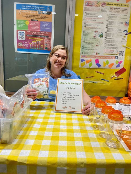 Traverse Area District Library staffer assists with Gather 2 Grow summer meals