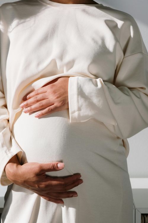 An image of a pregnant person holding their belly.