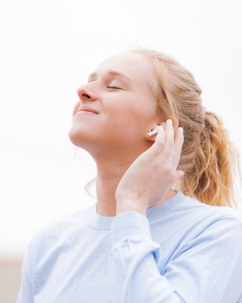 Young woman listening to music.