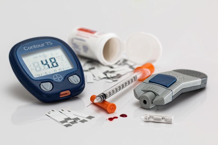 A photo of a blood sugar testing kit and insulin shot.