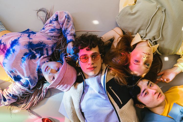 A group of diverse youth laying on the floor.