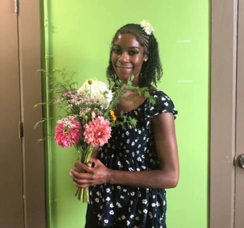 A woman holding a flower bouquet