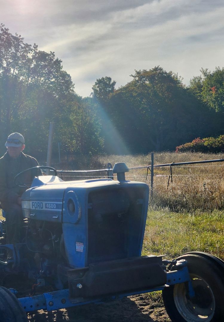 A farmer on a tractor.