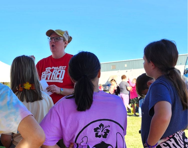 Sarah Hollon addresses a group of captivated students at 2024's Project RED event.