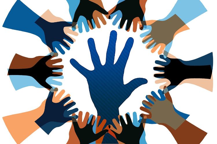 many hands reaching out in the shape of a circle with one large hand in the middle