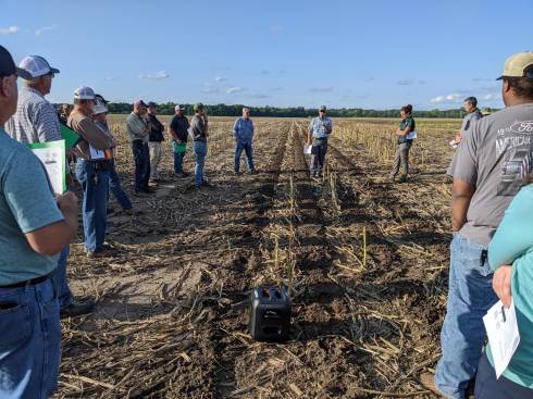 Event attendees observe a tillage equipment demonstration