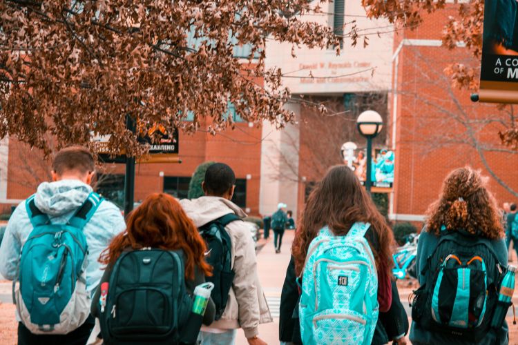 A group of kids walking with backpacks.