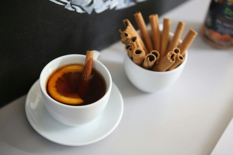 A drink with cinnamon sticks in it.