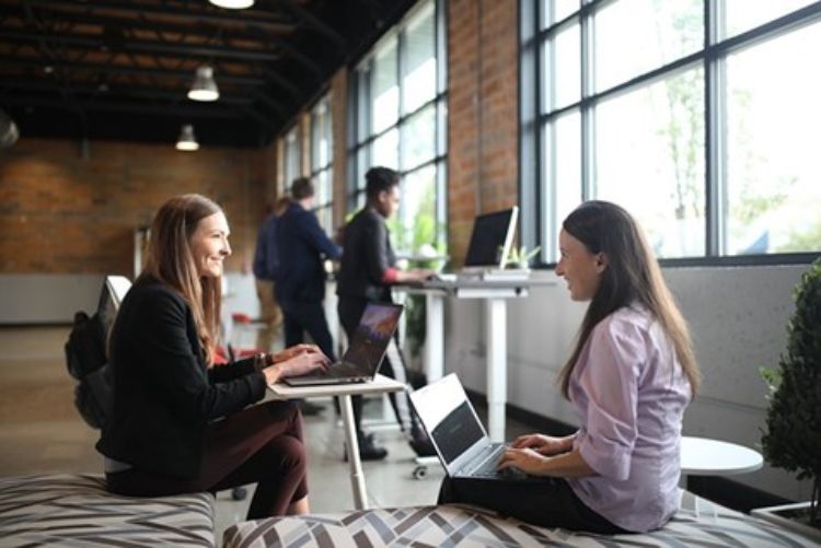 Two women talking at work.