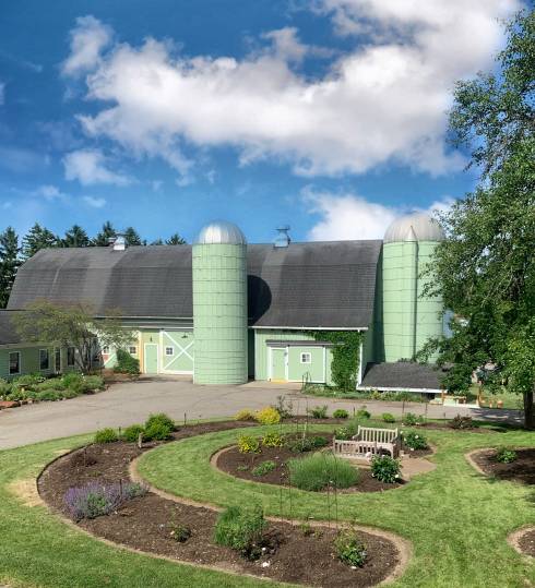View of Tollgate Farm's barn and rose garden