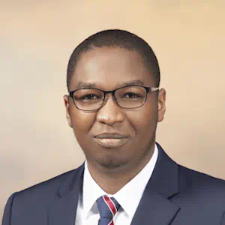 A headshot of Daniel Uyeh in front of a beige background