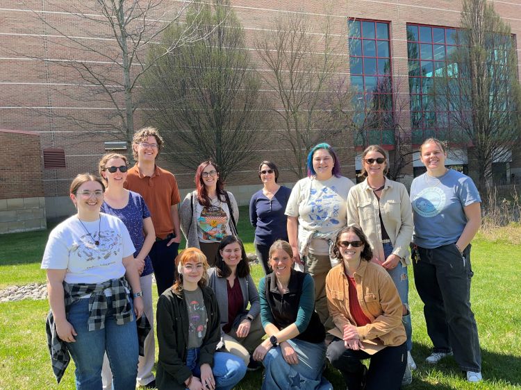 A group of people pose for a picture outdoors in the sunlight. Standing (left to right): Kaleigh Snoddy (CRWC), Erica Anculle, Ben Eiler (MSU), Emily Pomeranz (MSU), Angela Burrow (MSU), Lydia Nicholas (CRWC), McKenzi Waliczek (FDR), Sam Davis (FOTR). Sitting (left to right): Taylor Habedank Fuller (FSCR), Alexa Warwick (MSU), Lynnea McFadden (FSCR), Andrea Paine (HRWC); not pictured, Lauren Eaton (FOTR).