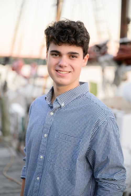 Young man in a blue shirt with dark hair.
