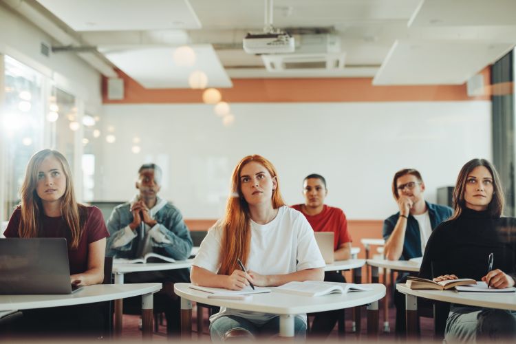 Students sitting in a classroom facing the front of the room.