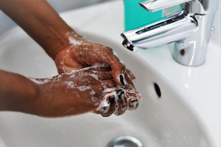 A person washing their hands.