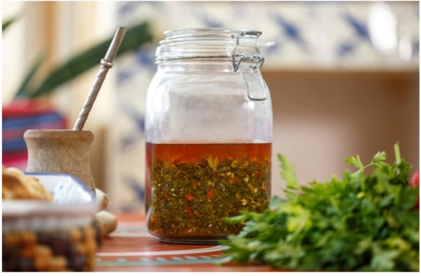 A jar of liquid with herbs and spices