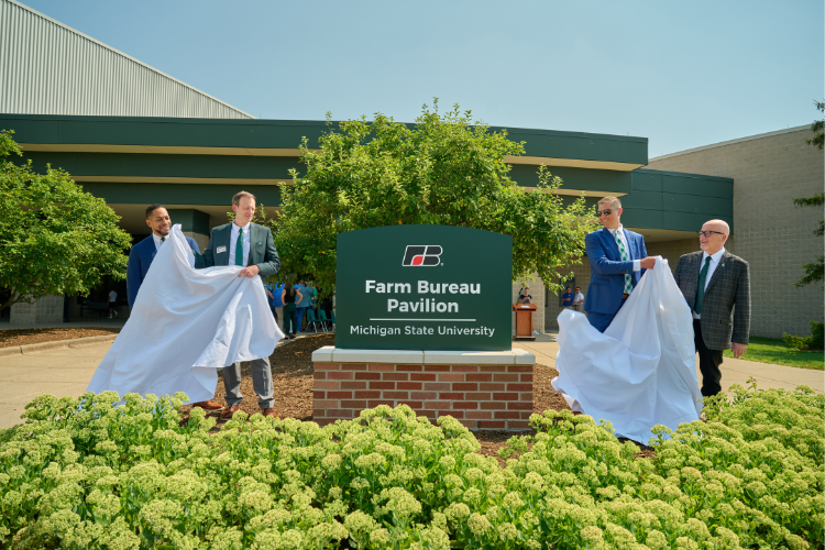 Image of leaders from CANR and MFB unveiling a new sign at the MFB Pavilion