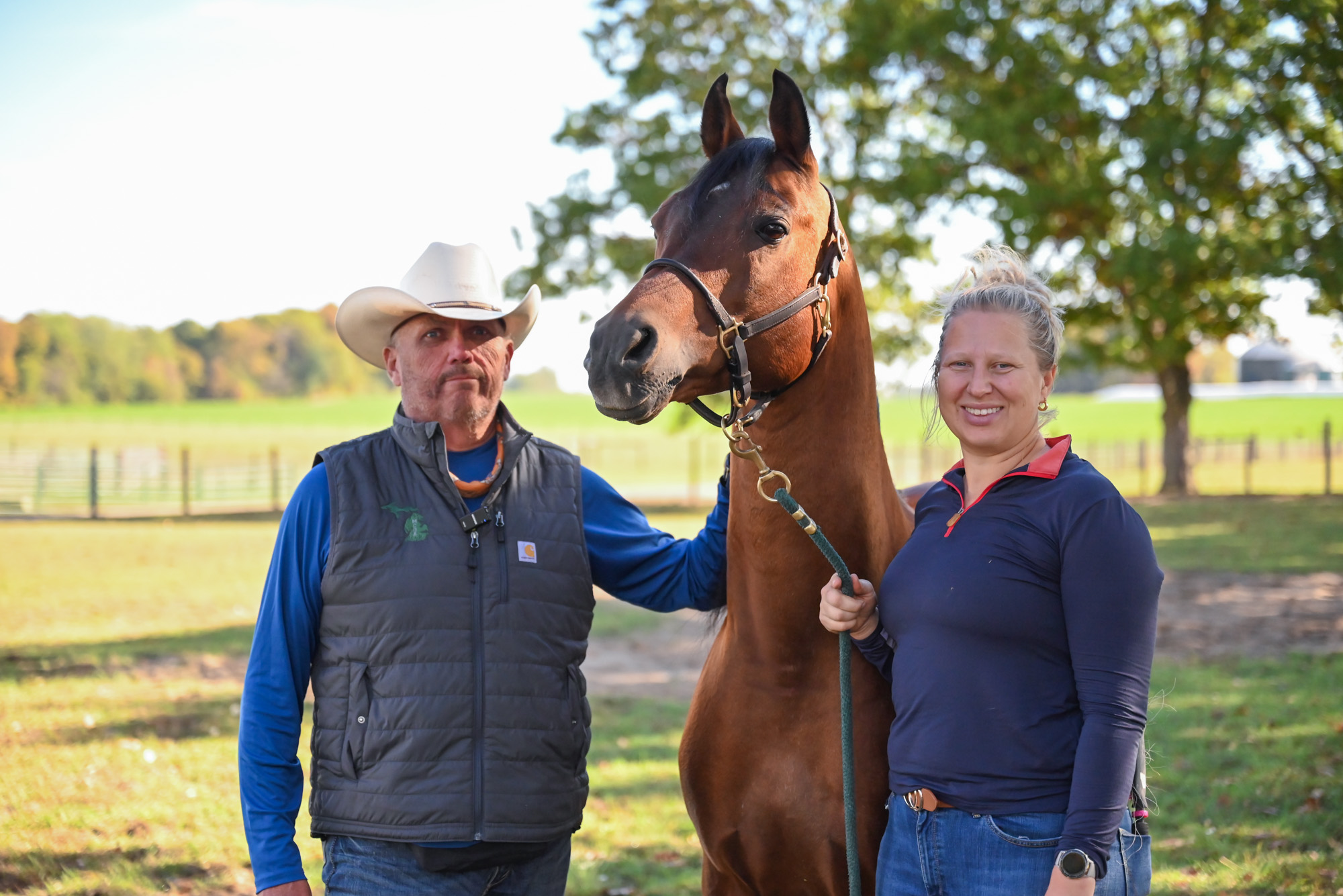 Gayelord Mankowski and Hannah Brink posing with Marco at the MSU Horse Teaching and Research Center. 