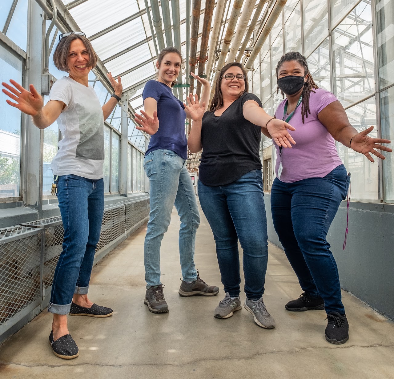 4 people in a greenhouse