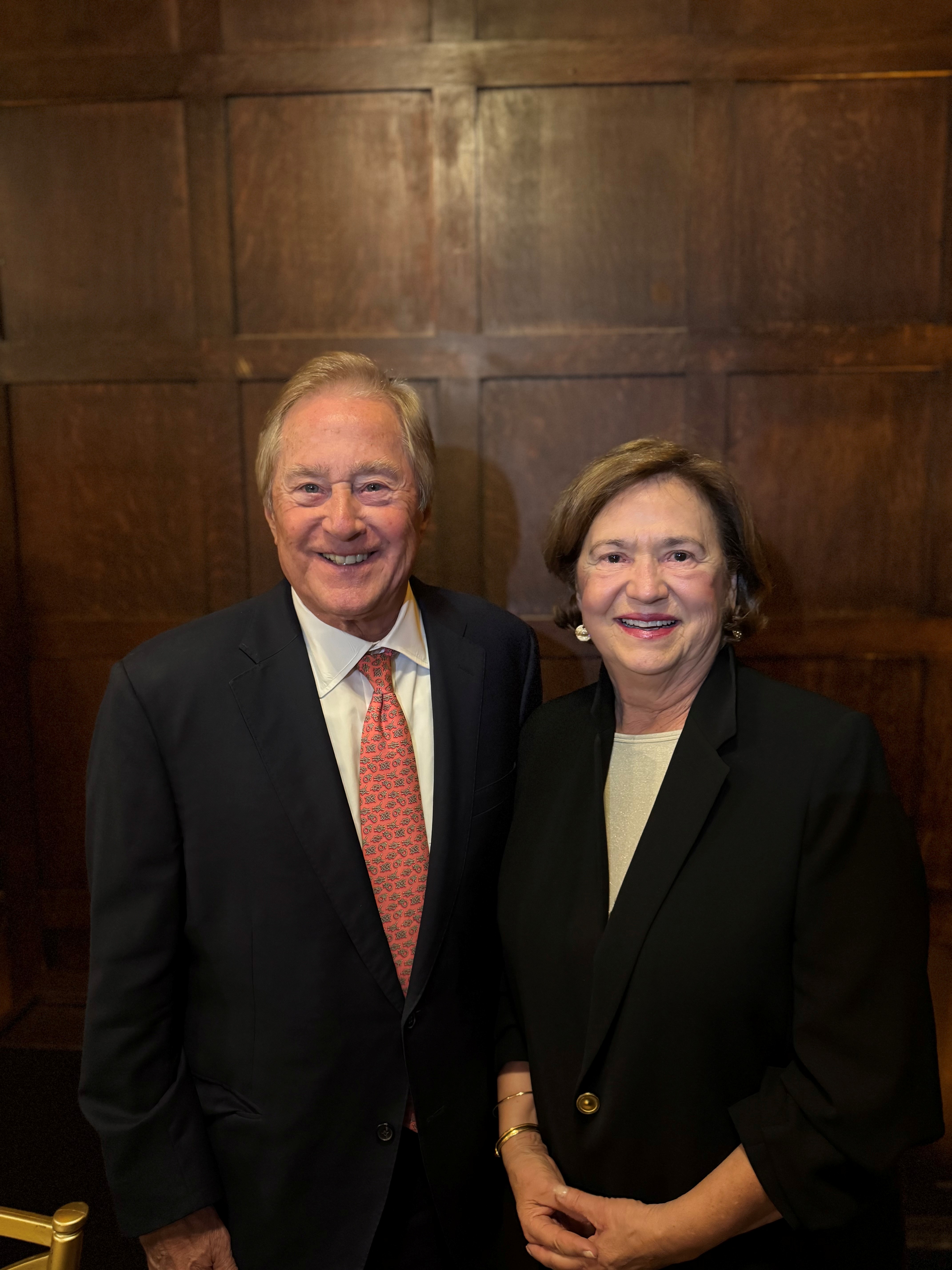 A man and a woman in suite jackets.