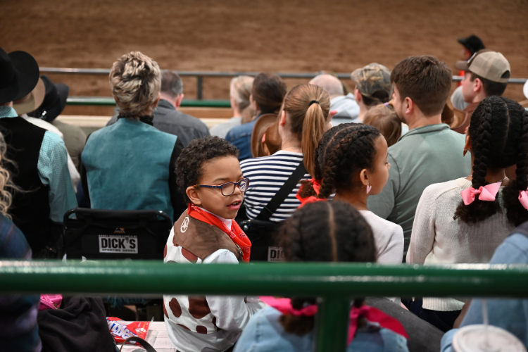 Two young fans watching the Spartan Stampede Rodeo.