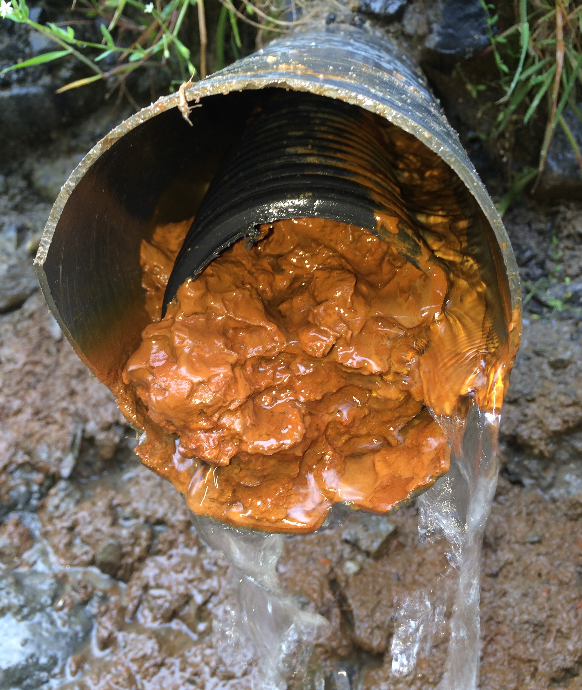 An extreme case of iron ochre deposits inside of a drain (photo credit: Patrick Ruohy)