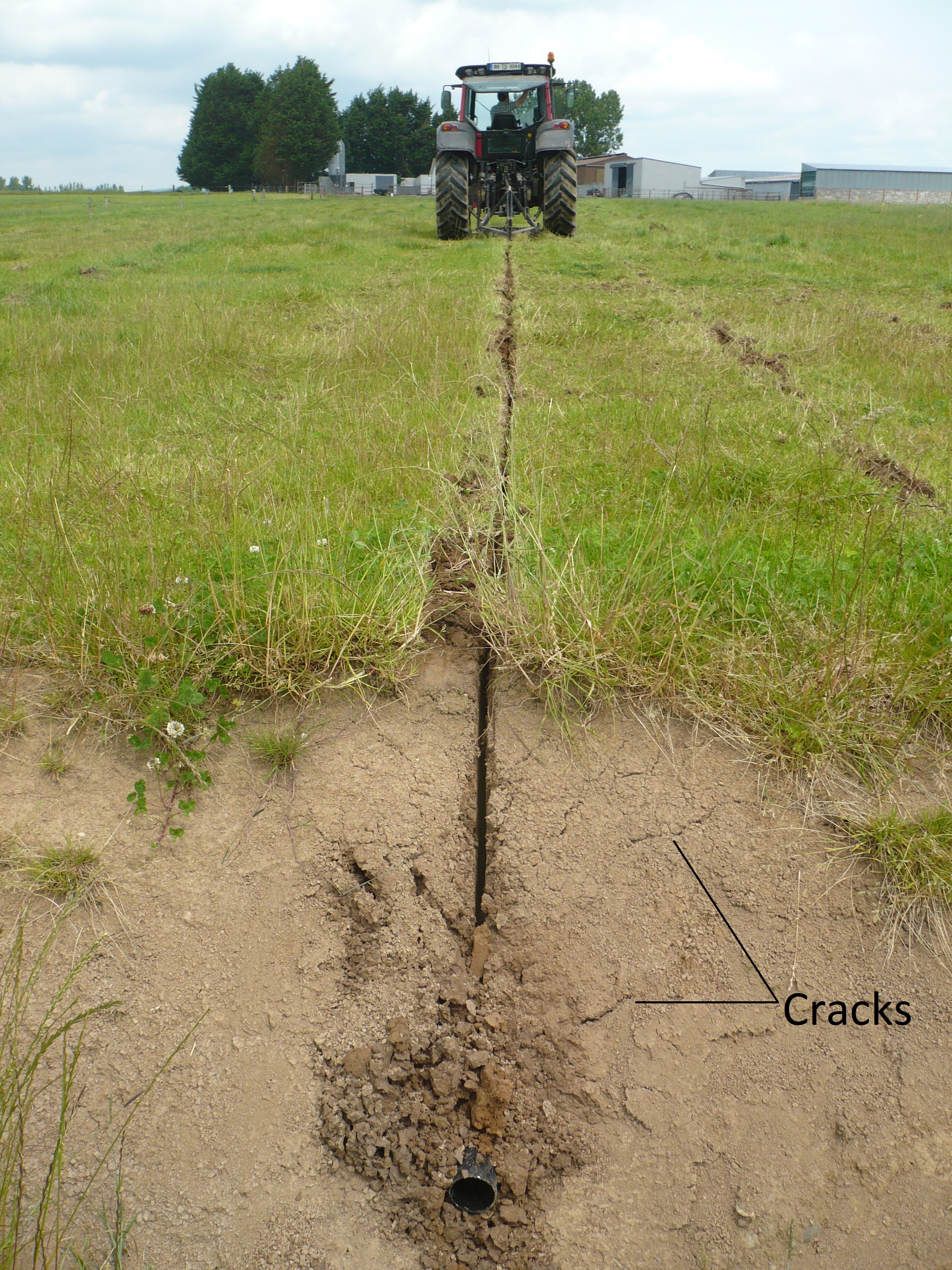 A rigid pipe at the outlet of a mole channel. Notice the soil cracks visible above the outlet (photo credit: Patrick Tuohy).