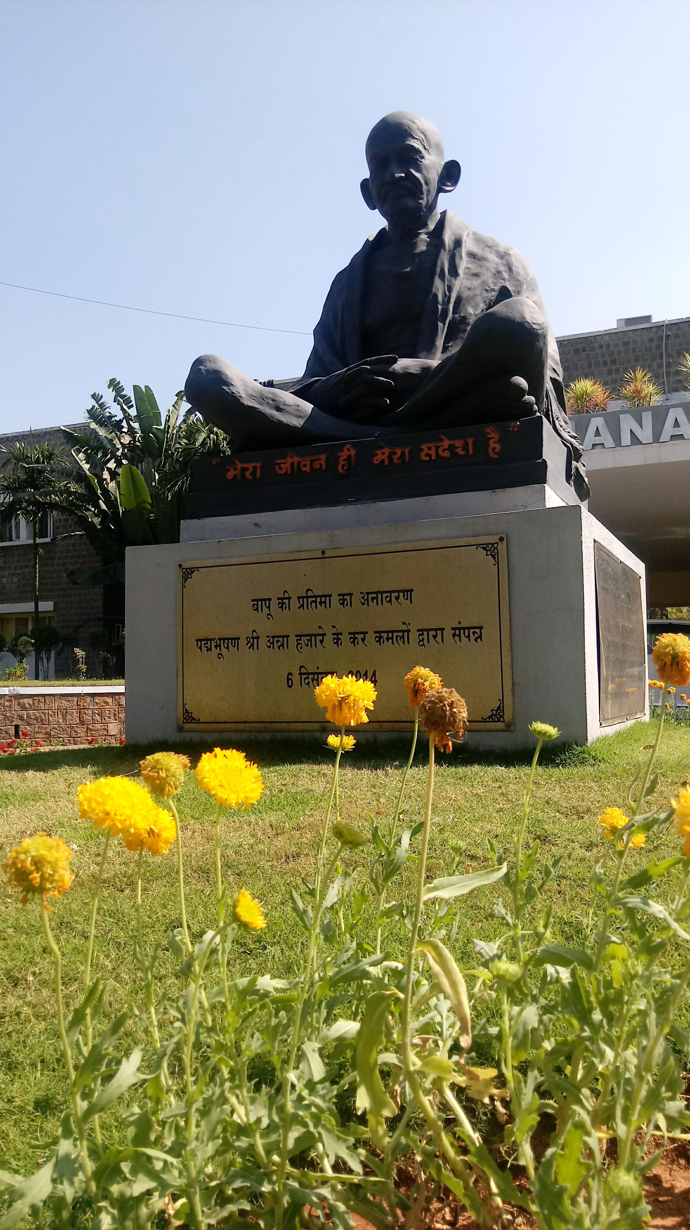 Photo of outside statue of Budha on outdoor campus
