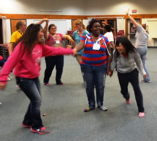 4-H youth participating in the Spanish Mixer dance at the Kettunen Center 2012 4-H Visual Arts & Crafts Workshop